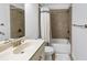 Tiled bathroom features a vanity with a sink, showerhead, bathtub, and white shower curtain at 2641 Se Parks Edge Se Dr, Smyrna, GA 30080