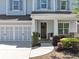 Inviting front porch and two-car garage with stone accents on this traditional-style home at 2641 Se Parks Edge Se Dr, Smyrna, GA 30080