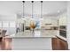 Bright kitchen features a large island, stainless steel appliances, and pendant lighting at 2641 Se Parks Edge Se Dr, Smyrna, GA 30080