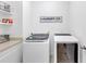 Laundry area with newer model washer and dryer and ample storage on white shelving at 2641 Se Parks Edge Se Dr, Smyrna, GA 30080