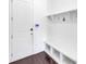 Mud room with custom built-in shelving, bench, and coat hooks for organization at 2641 Se Parks Edge Se Dr, Smyrna, GA 30080