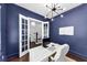 Stylish home office with custom built-ins, dark blue walls, and a large window at 2641 Se Parks Edge Se Dr, Smyrna, GA 30080