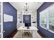 Stylish home office with custom built-ins, dark blue walls, and a large window at 2641 Se Parks Edge Se Dr, Smyrna, GA 30080