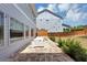 A brick patio with outdoor table and string lights in a fenced backyard provides a private entertaining space at 2641 Se Parks Edge Se Dr, Smyrna, GA 30080