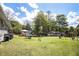 Large, grassy backyard with mature trees, gazebo, swing set and a storage shed providing outdoor space at 4061 Newman Ellis Rd, Douglasville, GA 30134