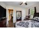Comfortable bedroom with a queen-sized bed, wood laminate flooring, and a view into the orange painted hall at 4061 Newman Ellis Rd, Douglasville, GA 30134