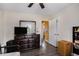 Cozy bedroom with wood laminate flooring, dresser, and ample storage; adjacent to an orange painted hall at 4061 Newman Ellis Rd, Douglasville, GA 30134
