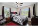 A well-lit bedroom offers a ceiling fan, two windows, and an inviting queen-sized bed at 4061 Newman Ellis Rd, Douglasville, GA 30134