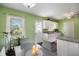 Bright kitchen with white cabinets, granite countertops, and a large window for natural light at 4061 Newman Ellis Rd, Douglasville, GA 30134