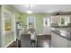 Eat-in kitchen featuring white cabinets and countertops, with a dining area under a modern light fixture at 4061 Newman Ellis Rd, Douglasville, GA 30134