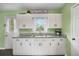 Bright and charming kitchen with white cabinets, granite countertops, and natural light from the window at 4061 Newman Ellis Rd, Douglasville, GA 30134