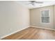 This bedroom features wood-look flooring and a ceiling fan with tan walls at 527 Pringle Dr, Suwanee, GA 30024