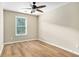 This bedroom features wood-look flooring and a ceiling fan with tan walls at 527 Pringle Dr, Suwanee, GA 30024