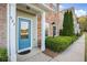 Charming townhouse with a blue front door, brick facade, and landscaped yard with mature trees at 527 Pringle Dr, Suwanee, GA 30024
