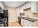 Charming kitchen features white cabinets, granite counters, tile backsplash, and stainless steel appliances at 527 Pringle Dr, Suwanee, GA 30024