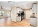 Open-concept kitchen with stainless steel appliances and granite countertops, flowing into a spacious living area at 527 Pringle Dr, Suwanee, GA 30024