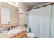 Well-lit bathroom has a granite countertop, wood cabinets, and a tiled shower at 2106 Berryhill Se Cir, Smyrna, GA 30082