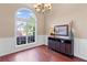 Dining room filled with natural light, featuring hardwood floors, stylish console table, and an elegant chandelier at 2106 Berryhill Se Cir, Smyrna, GA 30082