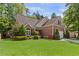 Beautiful brick home featuring a green lawn, enhanced by well-placed landscaping and mature trees in the background at 2106 Berryhill Se Cir, Smyrna, GA 30082