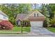 Charming brick and tan home with a well-manicured lawn, complemented by mature trees and lovely landscaping at 2106 Berryhill Se Cir, Smyrna, GA 30082
