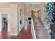 Open foyer featuring hardwood floors, staircase with iron spindles, built-in shelving, and views into the living area at 2106 Berryhill Se Cir, Smyrna, GA 30082