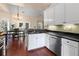 Open kitchen featuring white cabinets, stainless steel appliances, a dining area, and hardwood floors throughout at 2106 Berryhill Se Cir, Smyrna, GA 30082