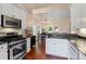 Bright kitchen with stainless steel appliances, granite countertops, white cabinets, and hardwood floors at 2106 Berryhill Se Cir, Smyrna, GA 30082