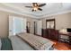 Comfortable main bedroom featuring a tray ceiling, wood accents, and ample closet space at 2106 Berryhill Se Cir, Smyrna, GA 30082