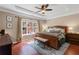 Serene main bedroom with tray ceilings, large window, and wood furniture at 2106 Berryhill Se Cir, Smyrna, GA 30082
