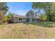 View of backyard with large grass area and green exterior of single story house at 350 Somerset Se Ln, Marietta, GA 30067