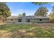 View of backyard with large grass area and green exterior of single story house at 350 Somerset Se Ln, Marietta, GA 30067