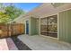 Backyard patio with sliding glass doors, a blue door, and a wooden fence at 350 Somerset Se Ln, Marietta, GA 30067