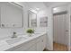 Bathroom with double sinks, marble countertops, modern faucets, and a separate shower area at 350 Somerset Se Ln, Marietta, GA 30067