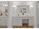 Bright bathroom with a vanity, large mirror, and white cabinets providing ample storage space at 350 Somerset Se Ln, Marietta, GA 30067
