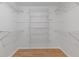 Walk-in closet with white wire shelving and hardwood floors, providing plenty of storage space at 350 Somerset Se Ln, Marietta, GA 30067