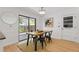 Cozy dining area with sliding glass door, wood table and modern light fixture at 350 Somerset Se Ln, Marietta, GA 30067
