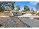 Charming single-story home with a stone facade, light-green wood siding, and a spacious concrete driveway at 350 Somerset Se Ln, Marietta, GA 30067