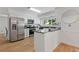 Well-lit kitchen featuring white cabinets, granite countertops, stainless steel appliances and a breakfast bar at 350 Somerset Se Ln, Marietta, GA 30067