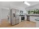 Bright kitchen featuring stainless steel appliances, granite countertops, and pristine white cabinets at 350 Somerset Se Ln, Marietta, GA 30067