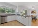 Well-lit kitchen featuring white cabinets, granite countertops, stainless steel appliances and a breakfast bar at 350 Somerset Se Ln, Marietta, GA 30067