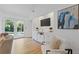 Bright living room with a television, double doors to the backyard, hardwood floors and built in storage at 350 Somerset Se Ln, Marietta, GA 30067