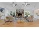 Bright living room with a stone fireplace, hardwood floors, neutral furniture, and double doors to the backyard at 350 Somerset Se Ln, Marietta, GA 30067