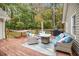 Back deck featuring wicker furniture, a hammock, a grill, and beautiful wooded views at 469 Kimberly Ct, Mcdonough, GA 30252