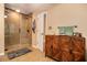 Bathroom with tiled shower, glass door, wood storage cabinet and neutral finishes at 469 Kimberly Ct, Mcdonough, GA 30252