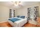 Bright bedroom featuring a queen-sized bed, hardwood floors and natural light at 469 Kimberly Ct, Mcdonough, GA 30252