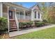 Charming home featuring a covered front porch, manicured landscaping, and brick accents at 469 Kimberly Ct, Mcdonough, GA 30252