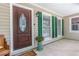 Inviting front porch showcasing a decorative wood door, green shutters, and lovely accents at 469 Kimberly Ct, Mcdonough, GA 30252