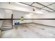 Spacious two-car garage interior with stairs to storage room at 469 Kimberly Ct, Mcdonough, GA 30252