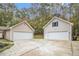Detached garages with a spacious driveway surrounded by mature trees at 469 Kimberly Ct, Mcdonough, GA 30252