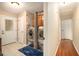 Bright laundry room with stainless steel washer and dryer set and tiled floor at 469 Kimberly Ct, Mcdonough, GA 30252